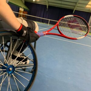 James pushing with the rubber strap on his angled aid