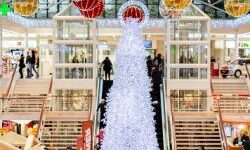 Christmas shopping centre with white Christmas tree and baubles hanging from the ceiling